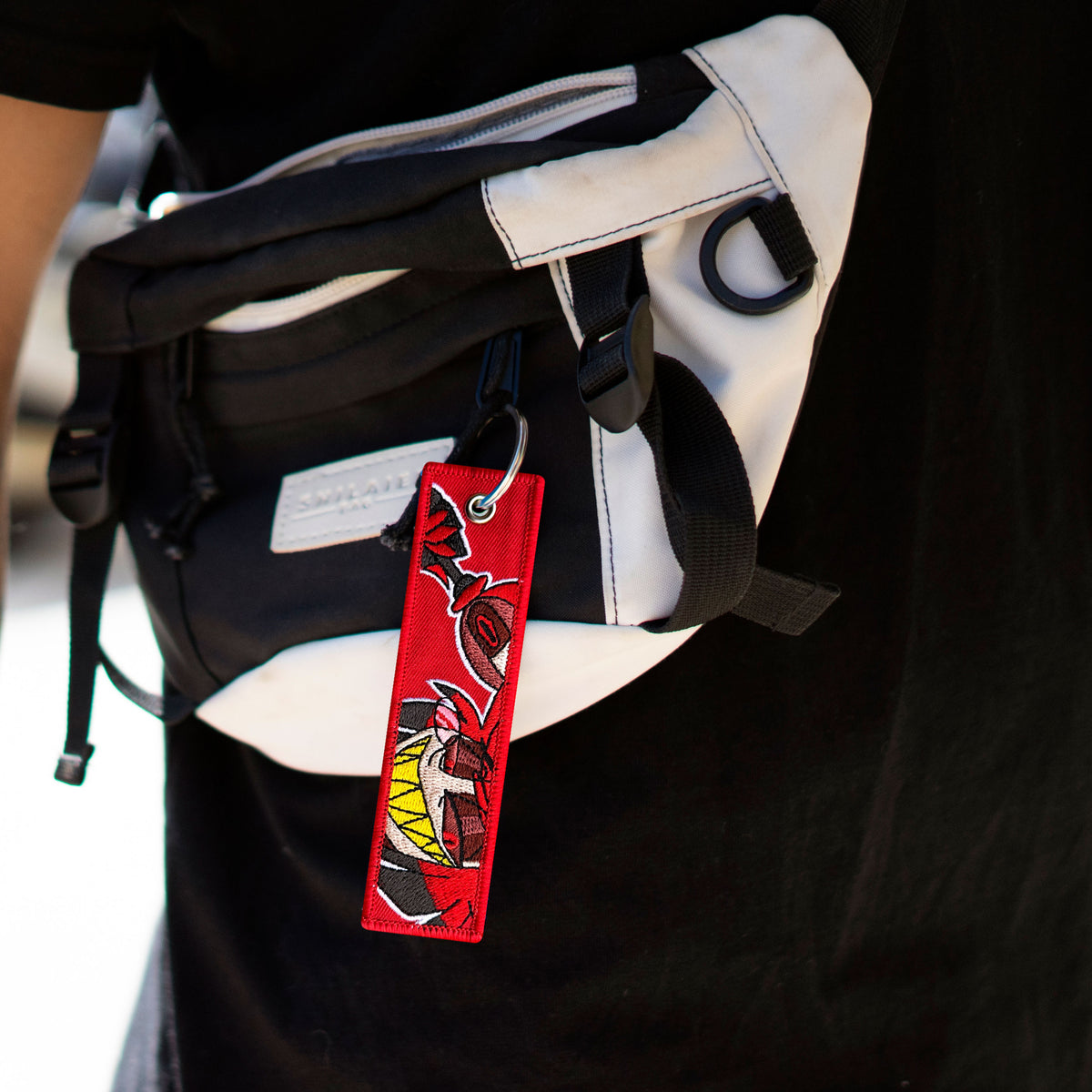 Detail of Alastor embroidered keychain – soft fabric anime-style keychain – Akira Gallery
