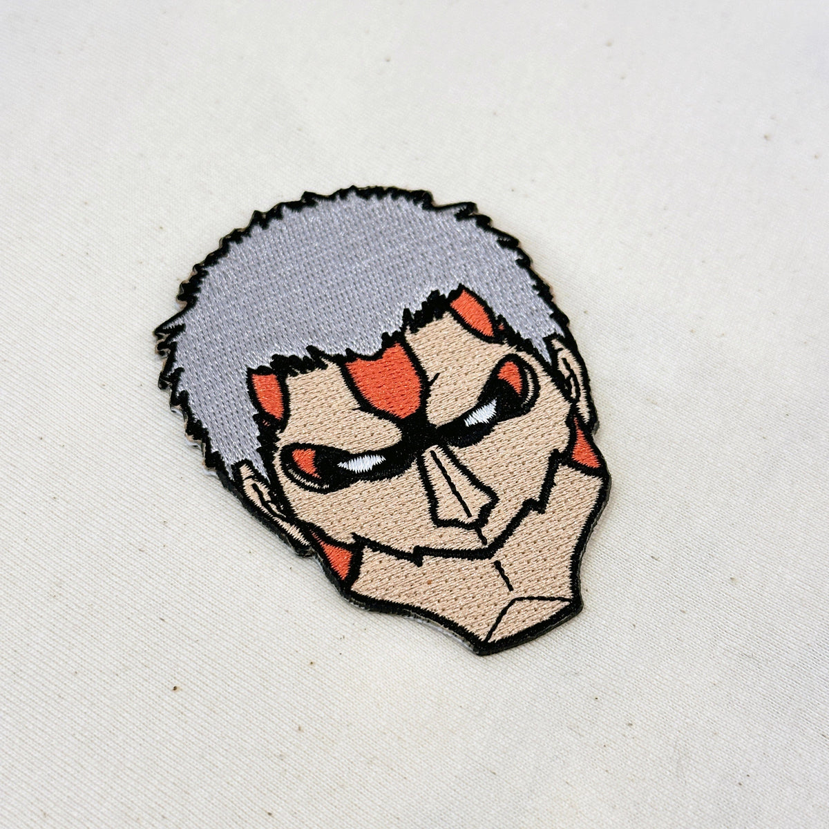 Detail of Armored Titan embroidered patch showing textured stitching – anime patch – Akira Gallery
