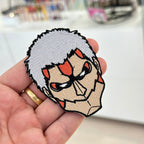 Display of Armored Titan embroidered patch showing textured stitching – anime patch – Akira Gallery
