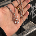 Brand Of Sacrifice Necklace from anime Berserk held by hand