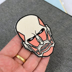 Display of Colossal Titan embroidered anime patch inspired by Attack on Titan with iron on backing – Akira Gallery
