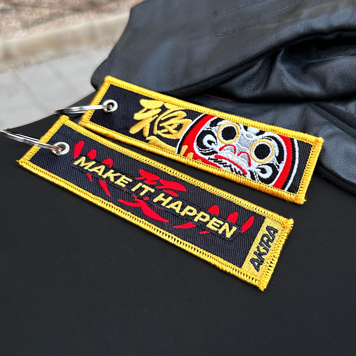 Detail of Daruma embroidered keychain – soft fabric embroidered keychain – Akira Gallery
