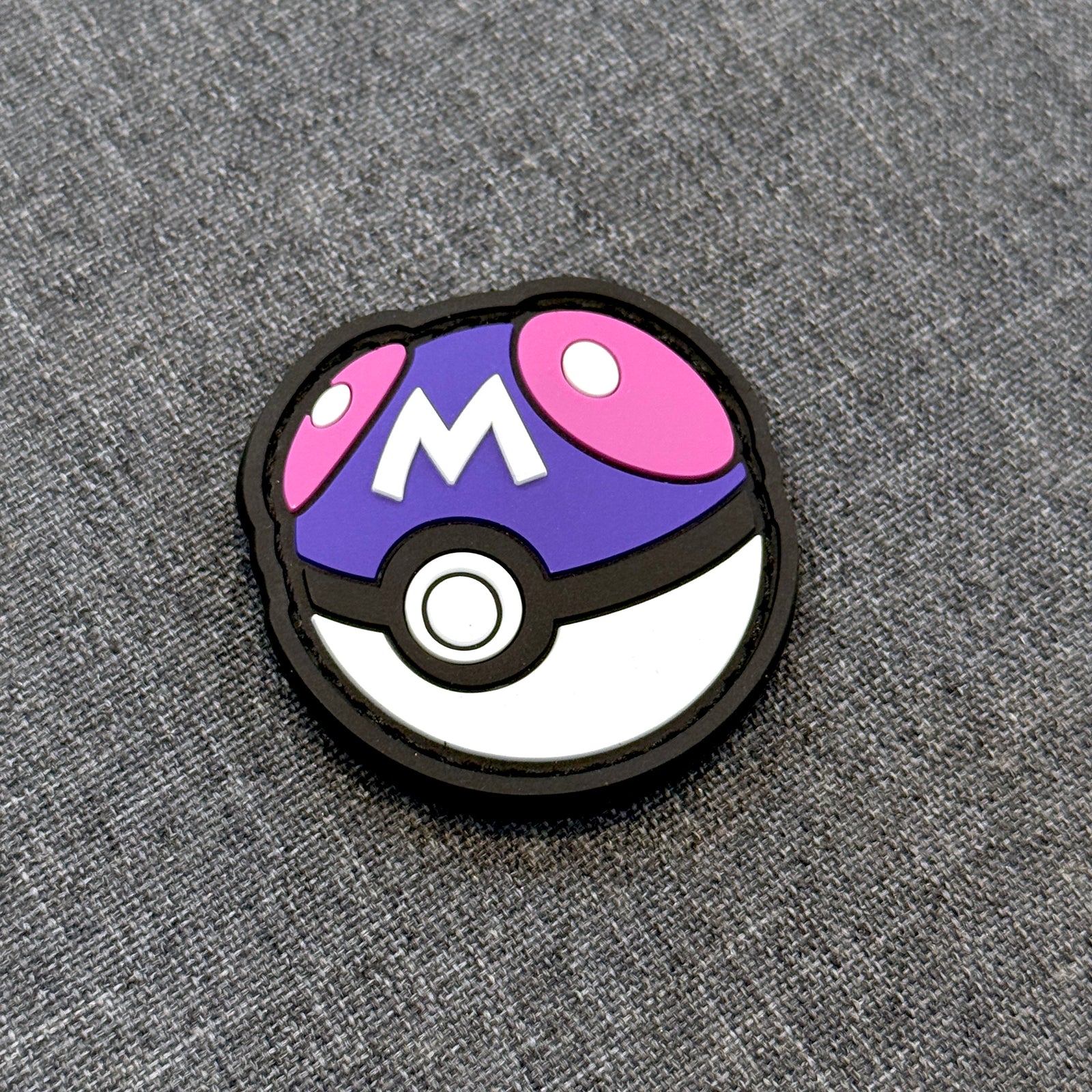 Display view of Master Ball PVC patch with velcro backing – Akira Gallery
