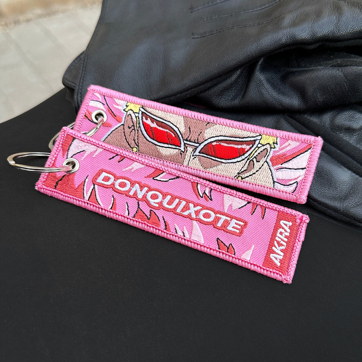 Display of Donquixote Doflamingo embroidered keychain – soft fabric anime keychain – Akira Gallery
