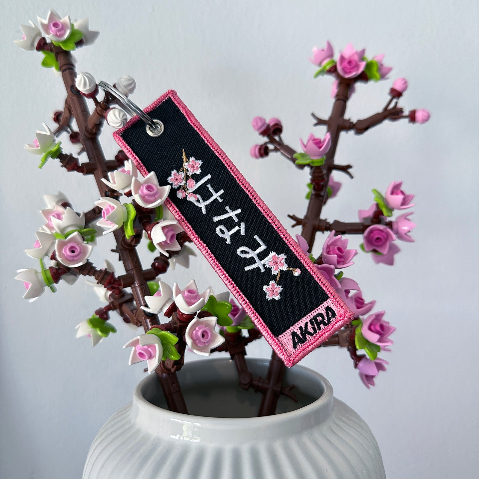 Back view of Hanami embroidered keychain – embroidered keychain – Akira Gallery
