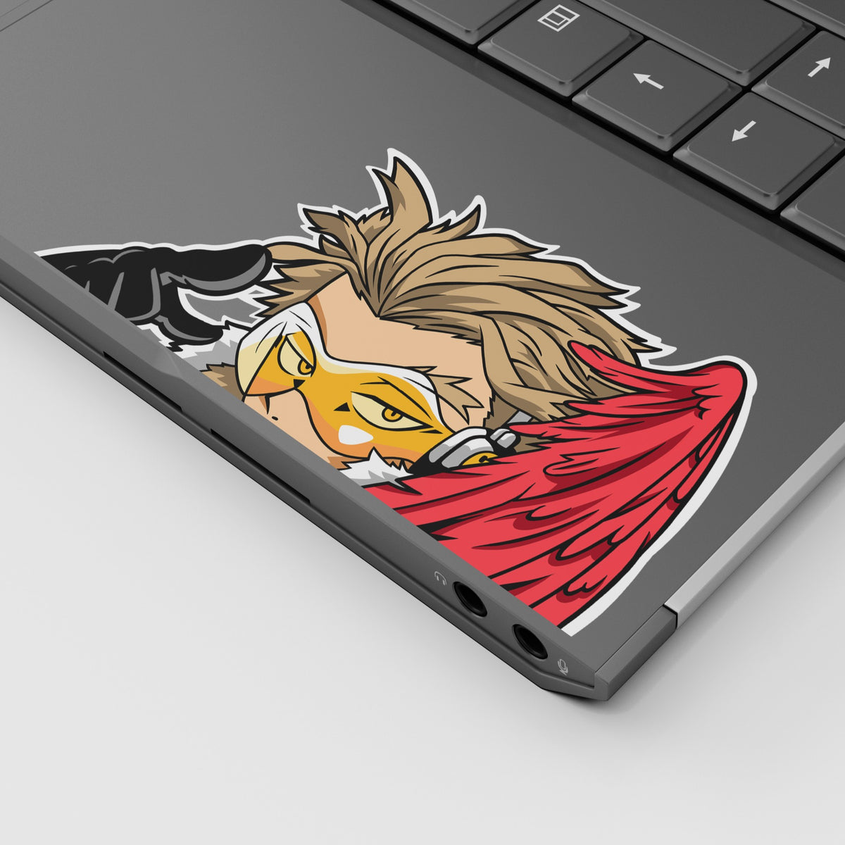 Hawks vinyl sticker from My Hero Academia displayed on a laptop