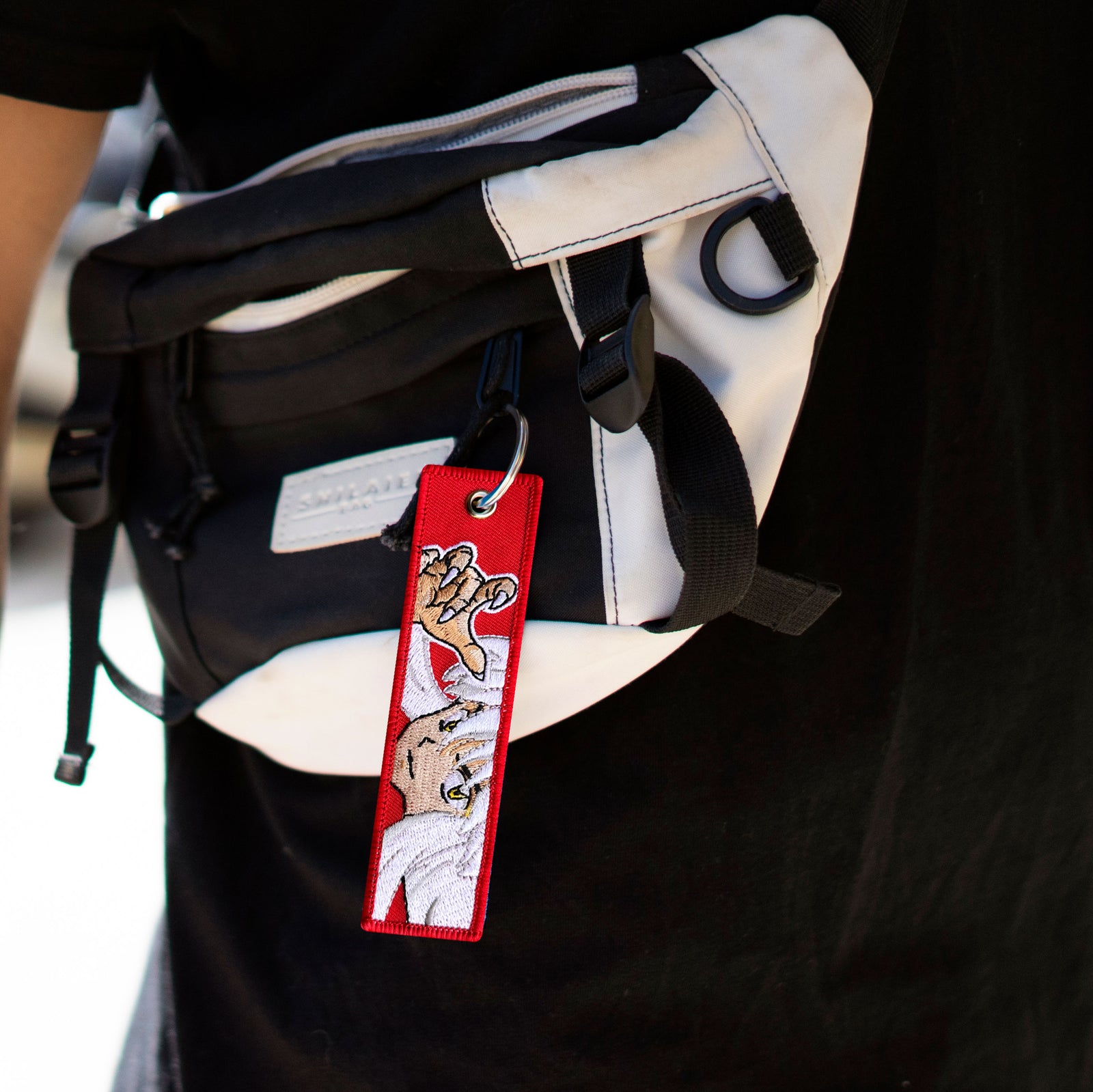 Anime Inuyasha & Sesshomaru embroidered double sided Keychain displayed on a bag