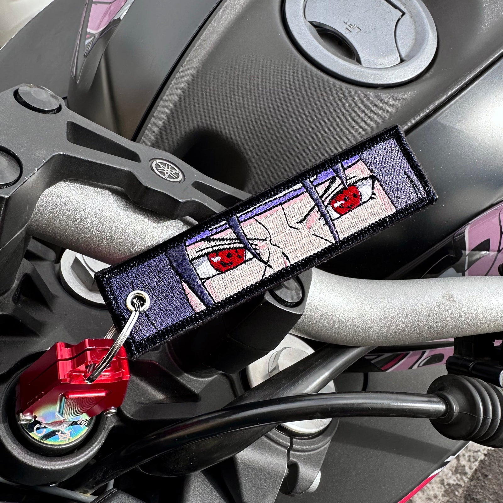 Front view of Itachi Uchiha embroidered keychain – anime keychain – Akira Gallery
