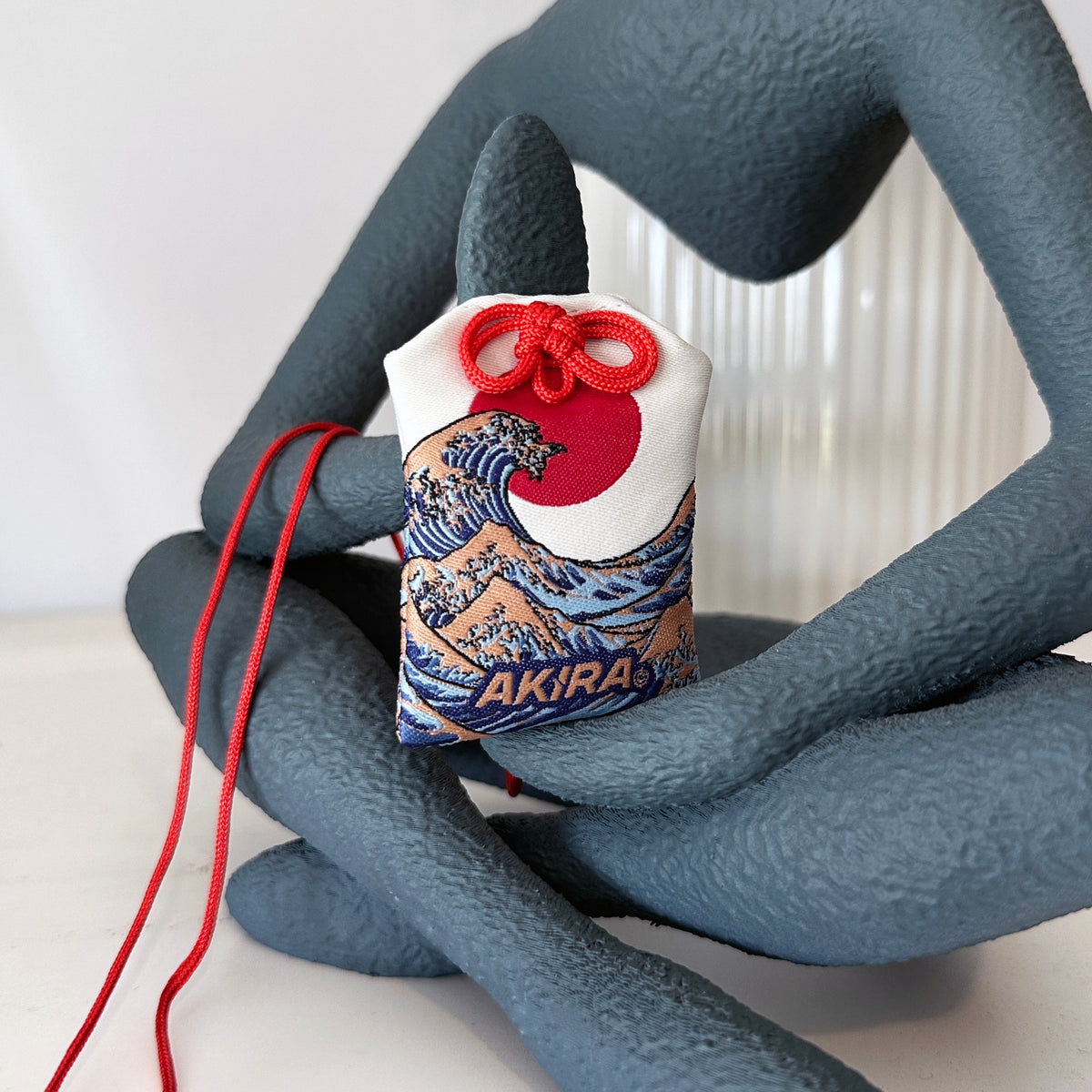 Great Wave omamori decorative charm inspired by ukiyo-e art
