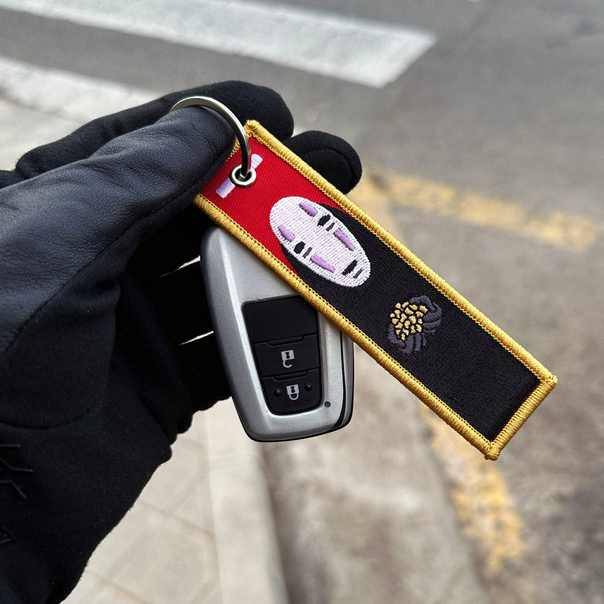 Front view of Kaonashi No-Face embroidered keychain – anime keychain – Akira Gallery
