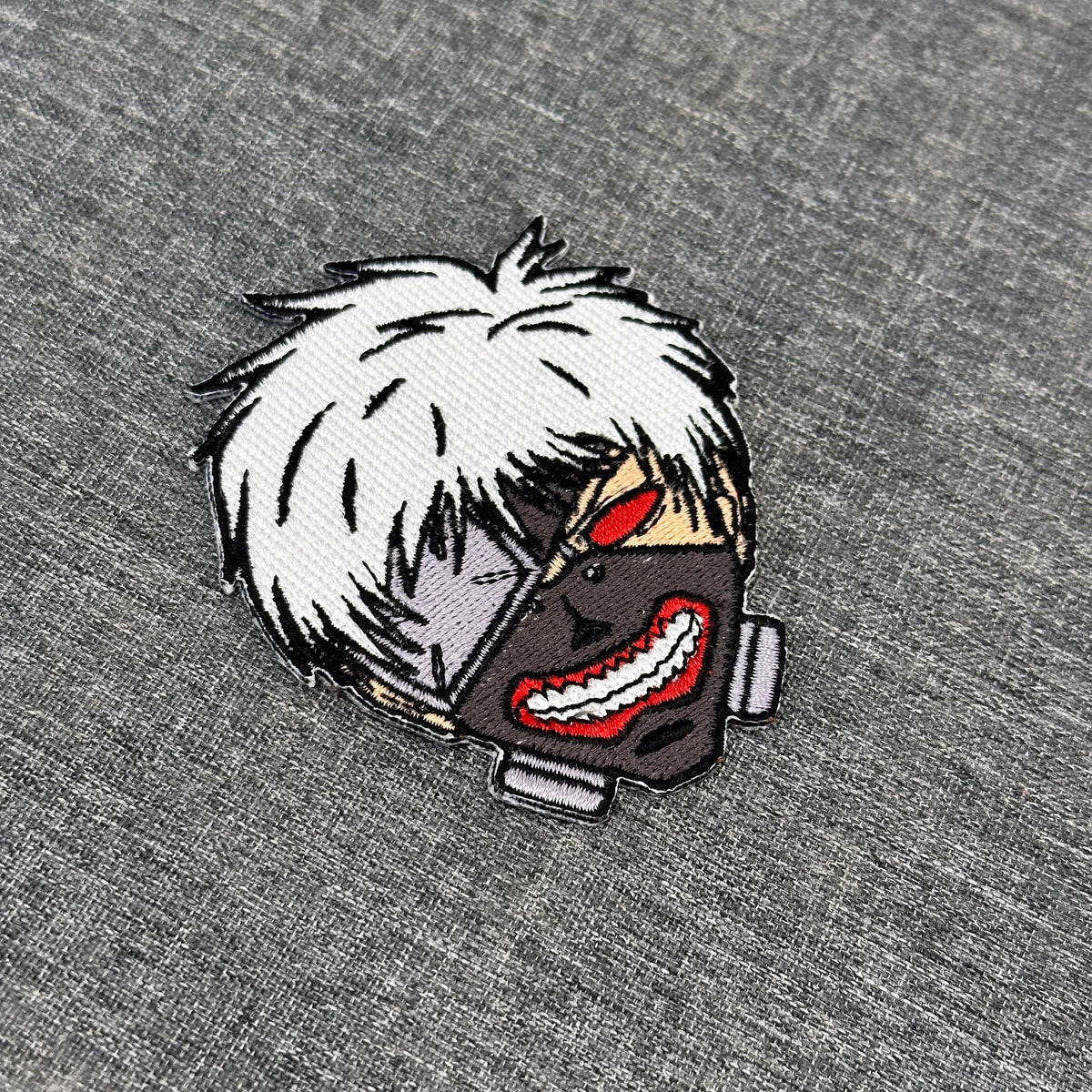 Detail of Ken Kaneki embroidered patch showing textured stitching – anime patch – Akira Gallery

