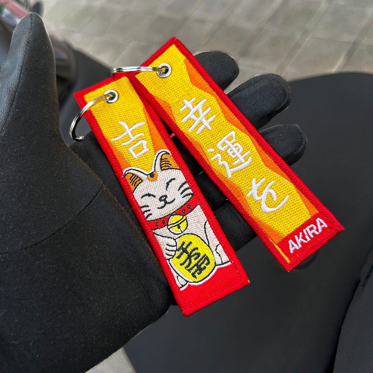 Detail of Maneki Neko embroidered keychain – soft fabric embroidered keytag – Akira Gallery
