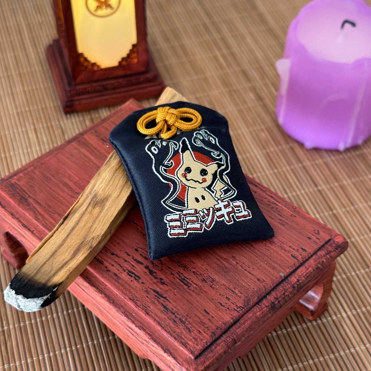 Mimikyu omamori decorative charm symbolizing mystery
