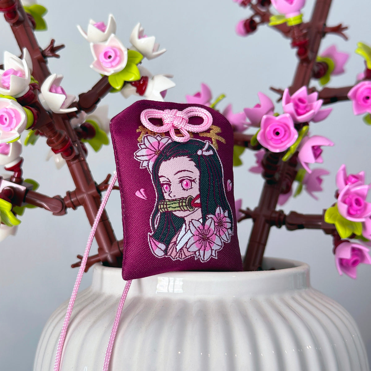 Nezuko Kamado omamori decorative charm symbolizing protection

