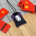Kaonashi omamori decorative charm symbolizing transformation
