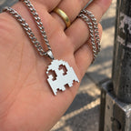 Pacman Stainless Steel Necklace featuring the iconic ghost of the arcade game held by hand