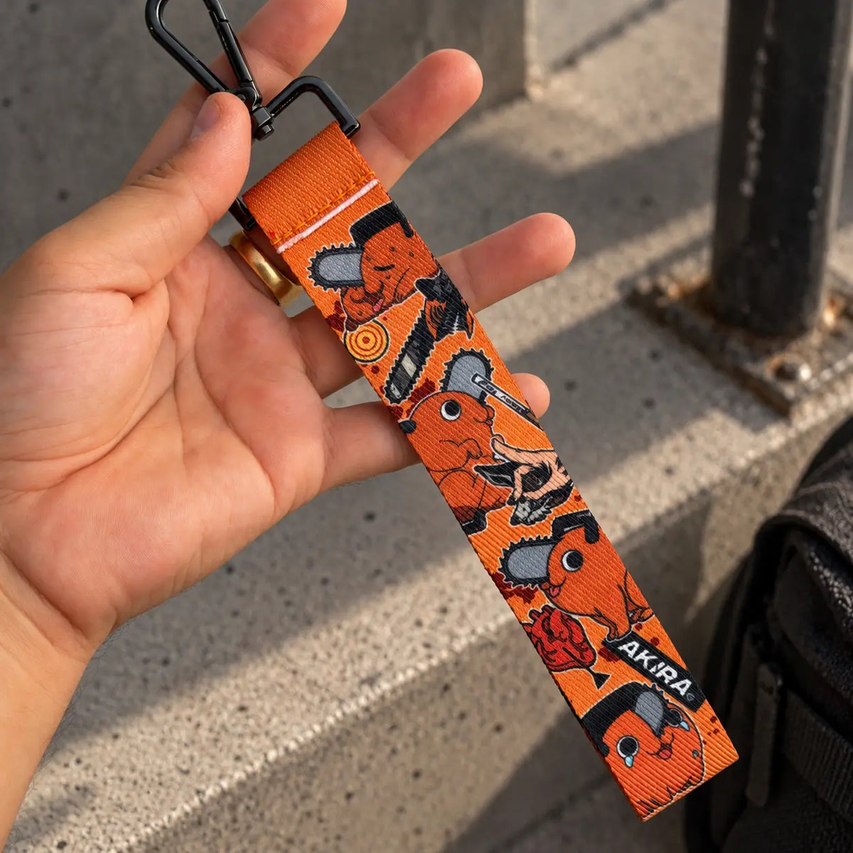 Pochita Wrist Lanyard or phone strap from anime Chainsaw Man held by hand
