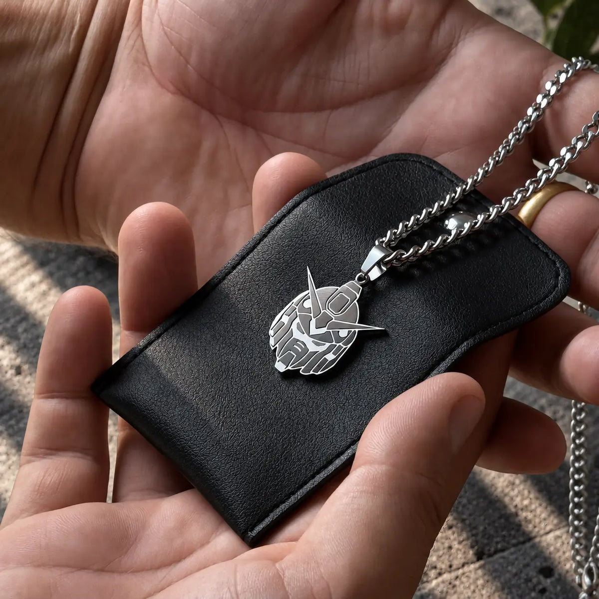 RX-78 Gundam Head stainless Steel Necklace displayed on a black bag