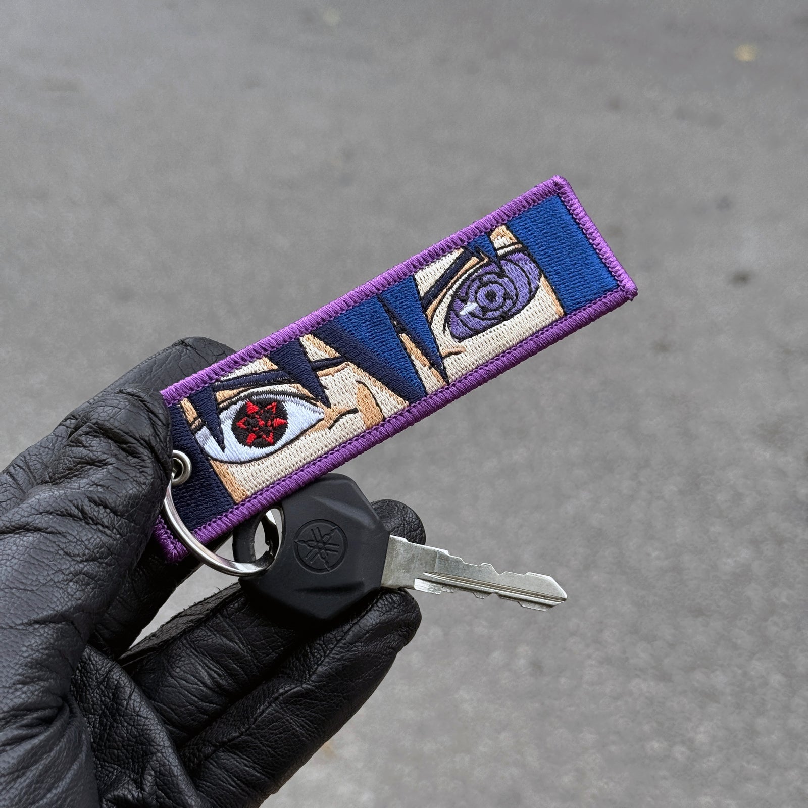 Front view of Sasuke Uchiha embroidered keychain – anime keychain – Akira Gallery
