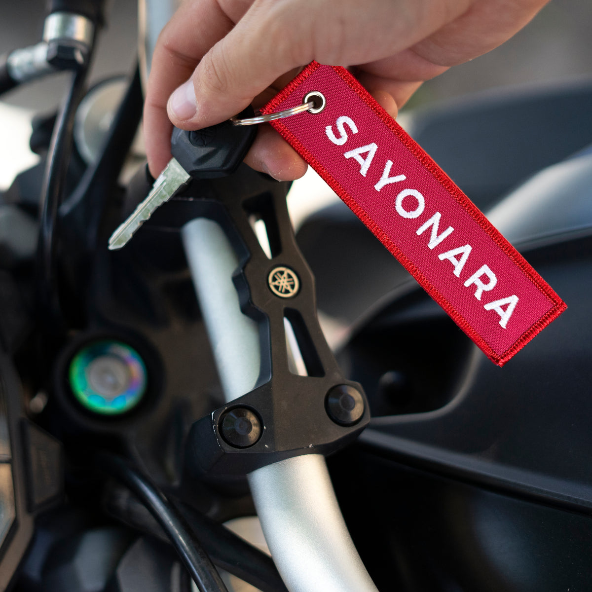 Detail of Sayonara embroidered keychain – soft fabric embroidered keychain – Akira Gallery
