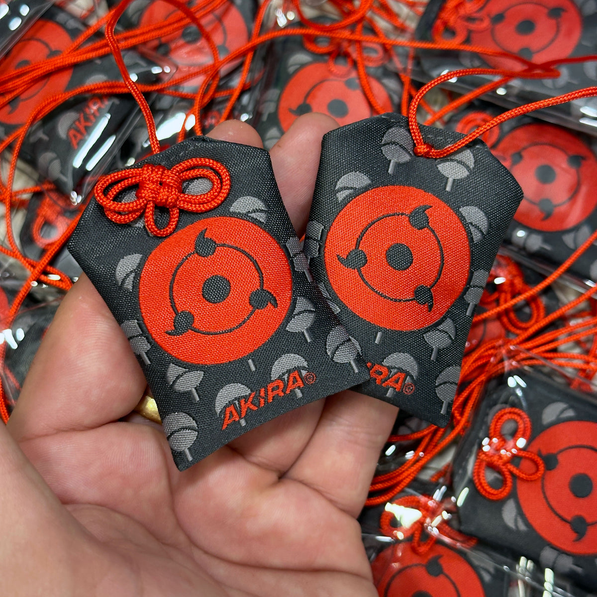 Anime-inspired Sharingan Japanese style omamori charm
