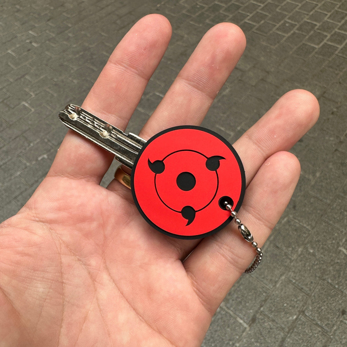 Detail of Sharingan anime key cover made of PVC – Akira Gallery
