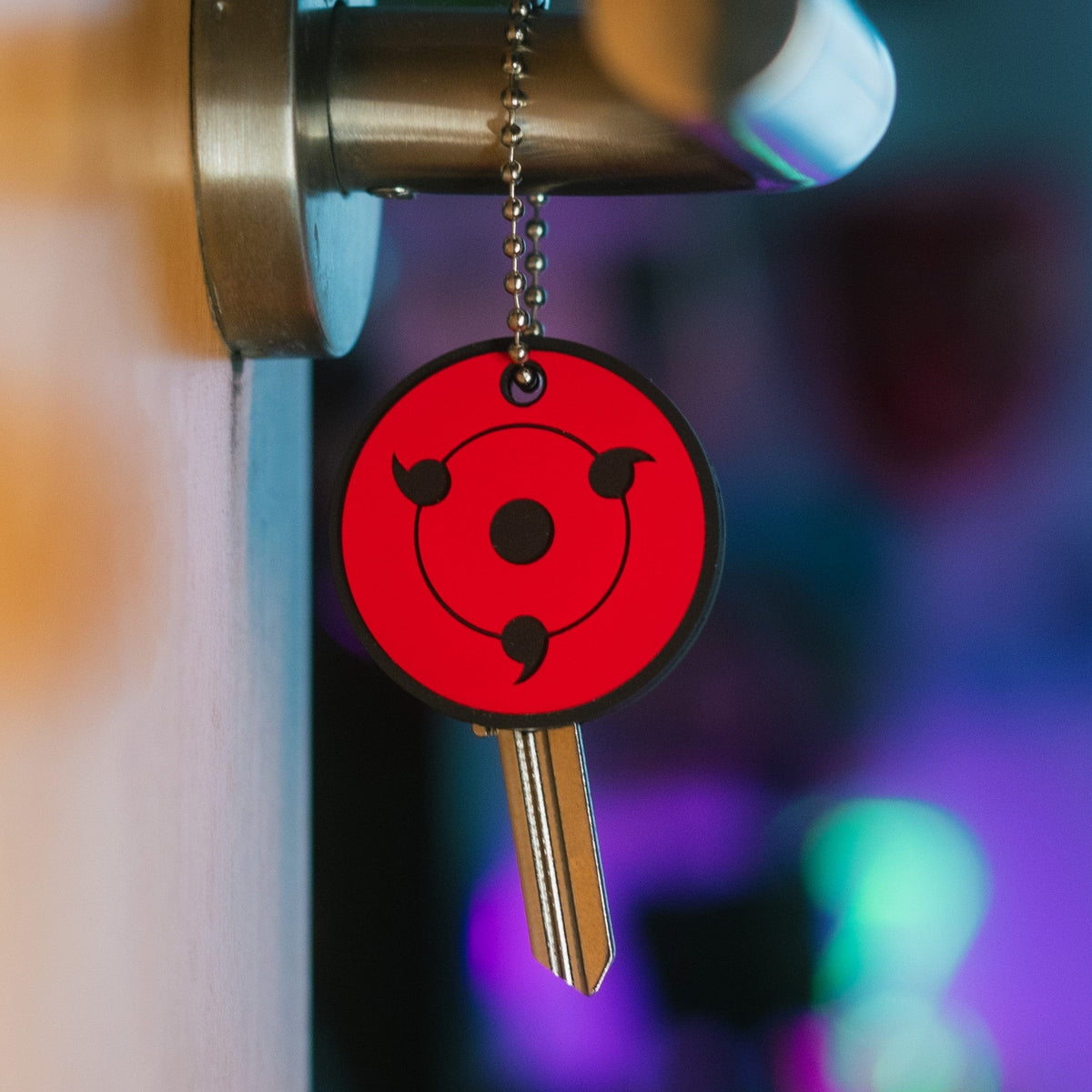 Display of Sharingan anime key cover made of PVC – Akira Gallery
