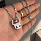 Hollow Knight Hero Stainless Steel Necklace inspired by Hollow Knight Game held by hand