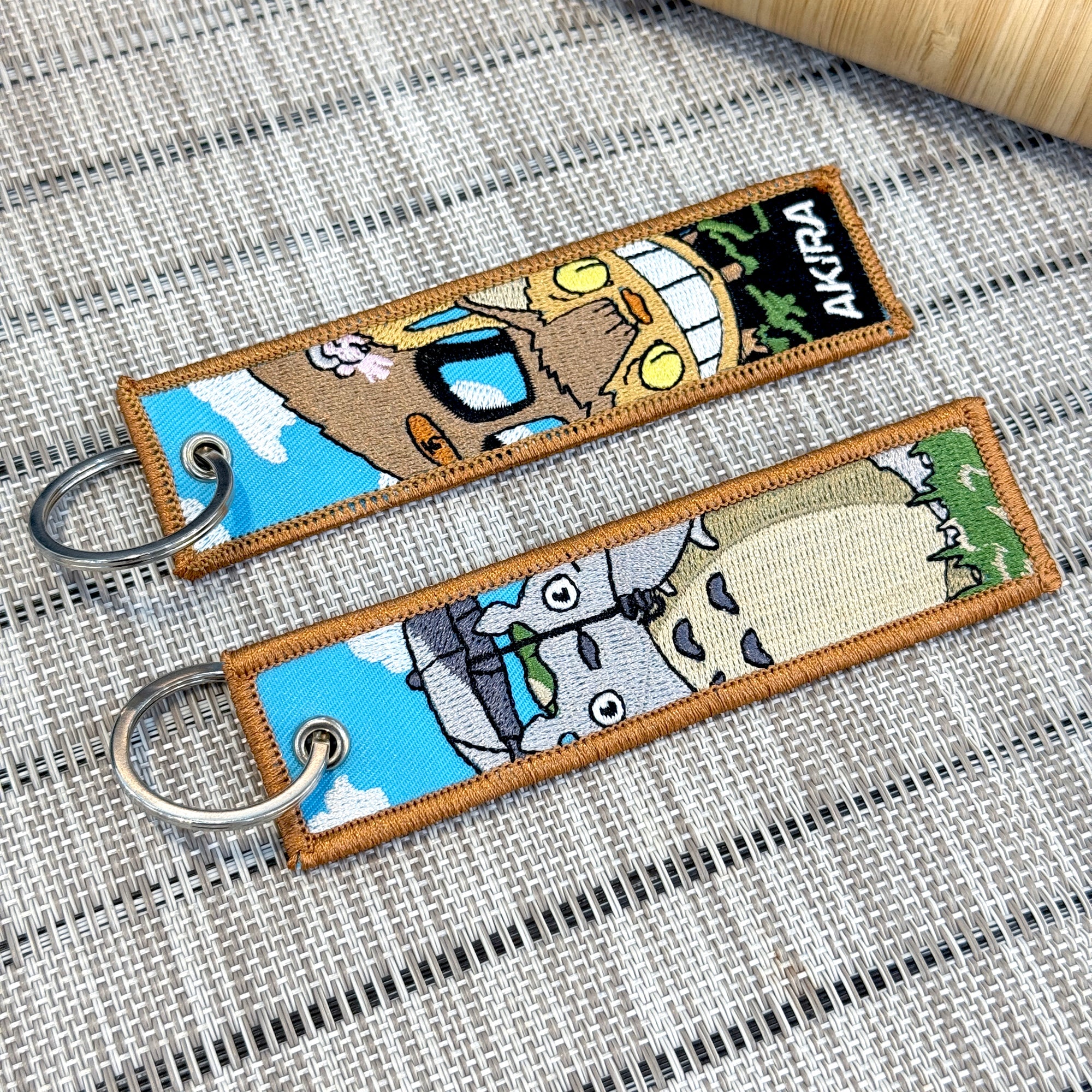 catbus and totoro on a double sided embroidered keychain from studo ghibli