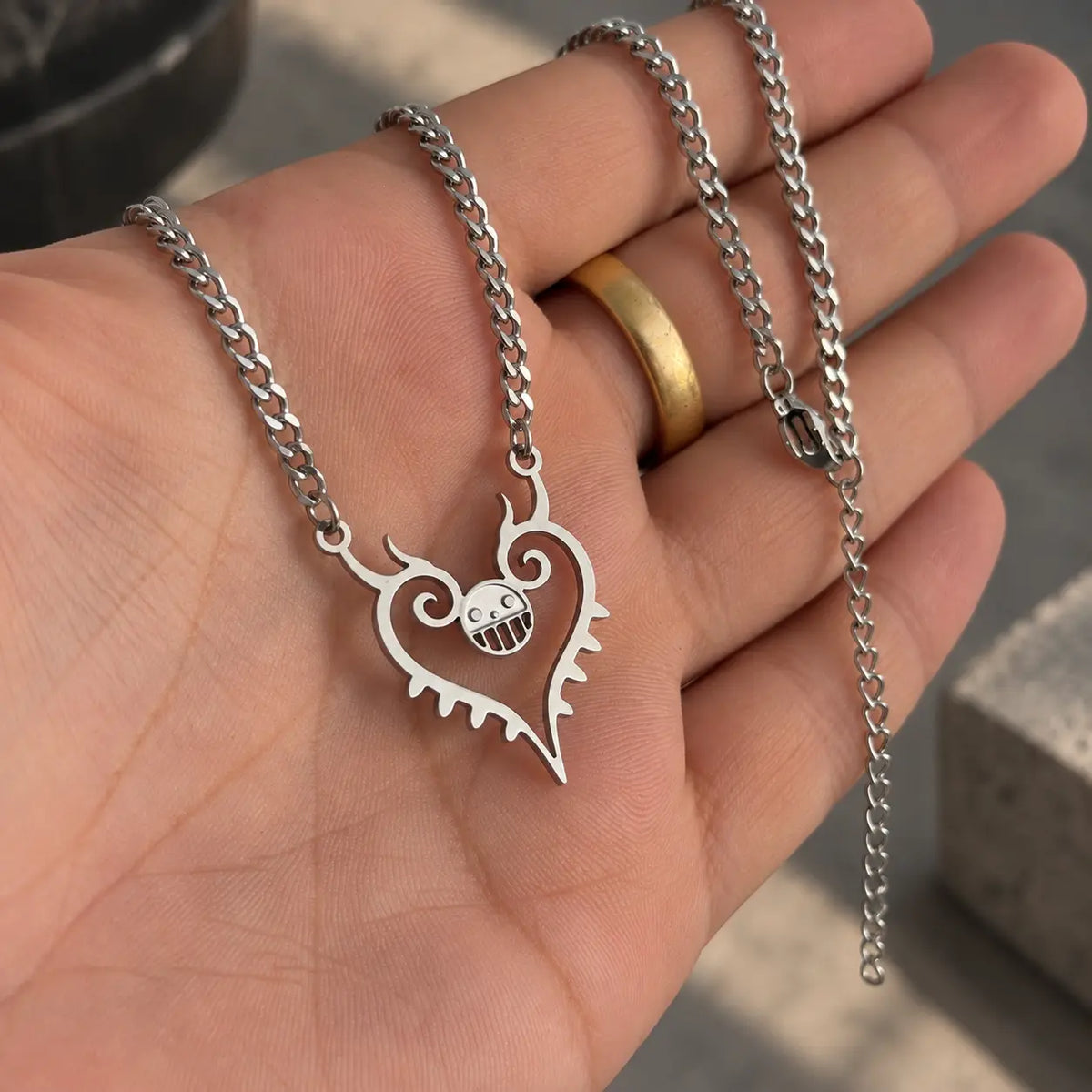 Trafalgar Law Heart Stainless Steel  Necklace from naime One Piece held by hand