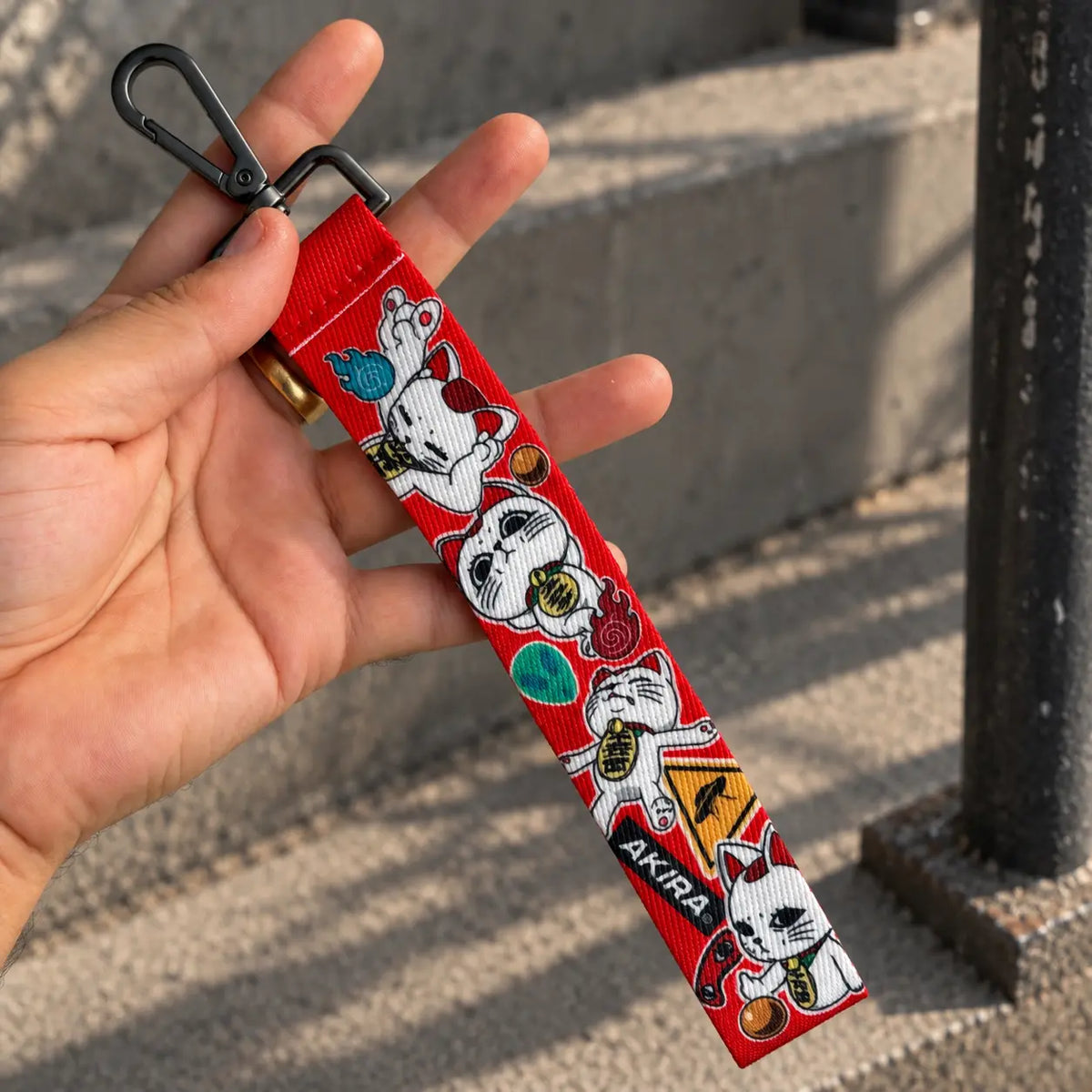 Turbo Granny Wrist Lanyard or phone strap from anime Dandadan held by hand
