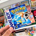 Pokémon Blue Version sticker with Blastoise held in front of a retro Pokémon game collection