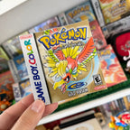 Pokémon Gold Version sticker with Ho-Oh held in front of a retro Pokémon game collection