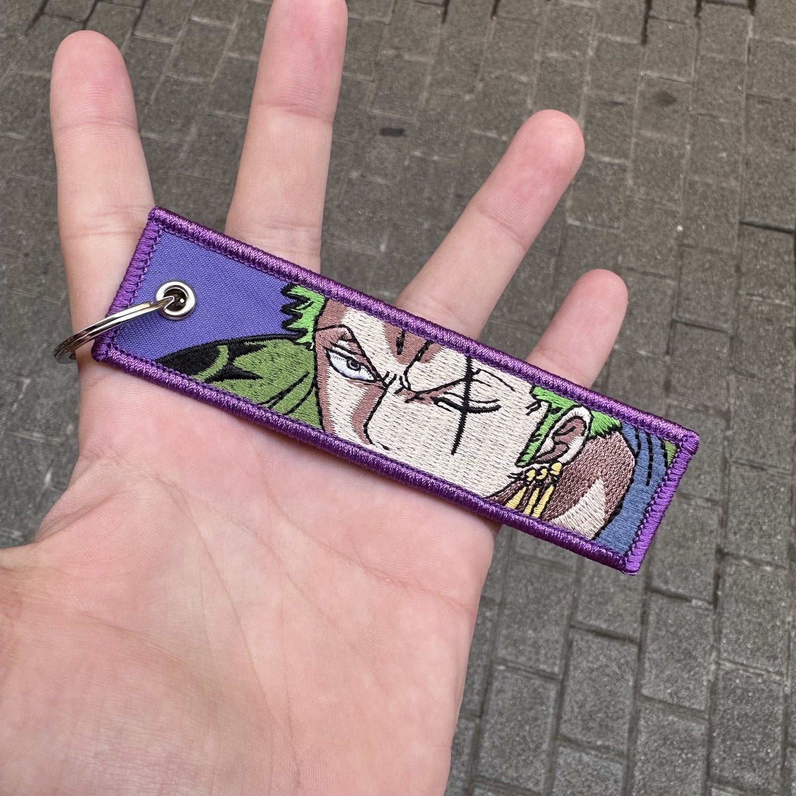 Front view of Roronoa Zoro embroidered keychain – anime keychain – Akira Gallery